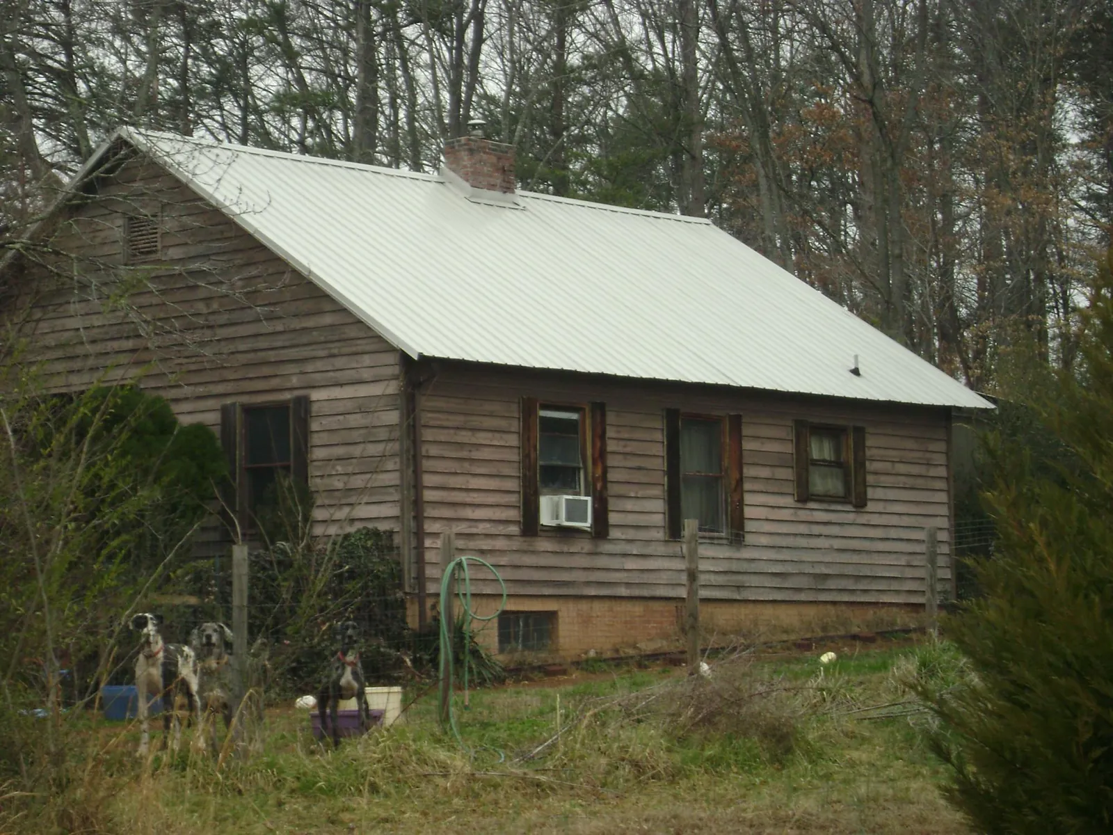 White metal roof on an old wood sided farmhouse, from a Metal Roof Installation job in Barnesville